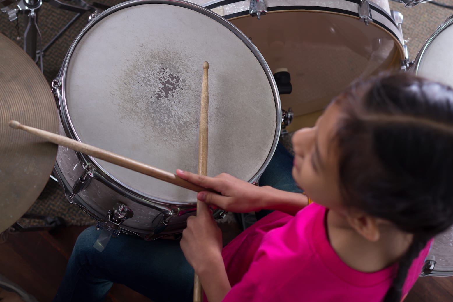 Young drummer seated at a drum kit