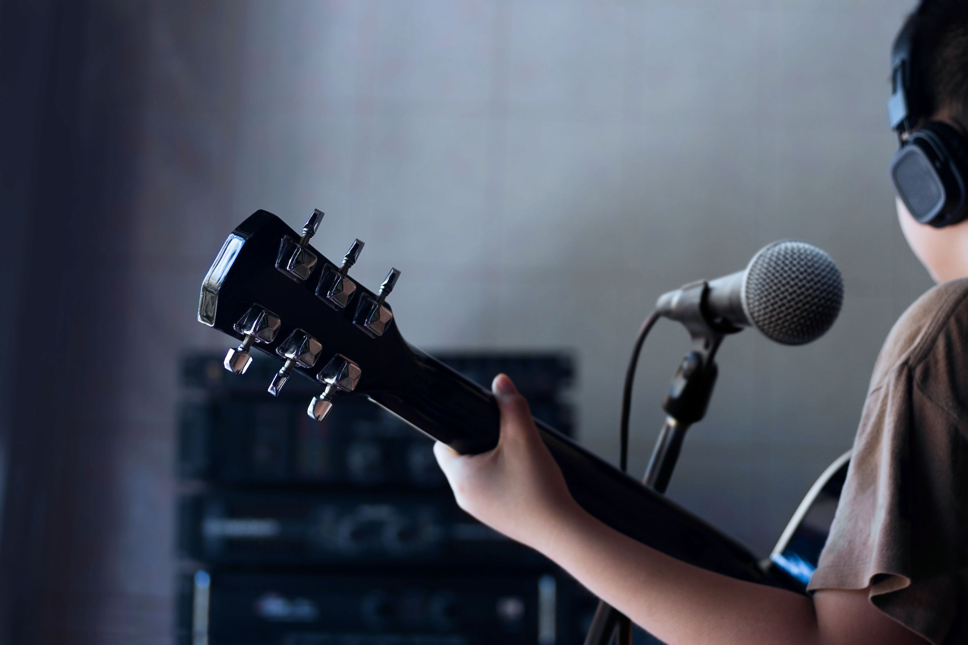 Guitarist playing near a microphone