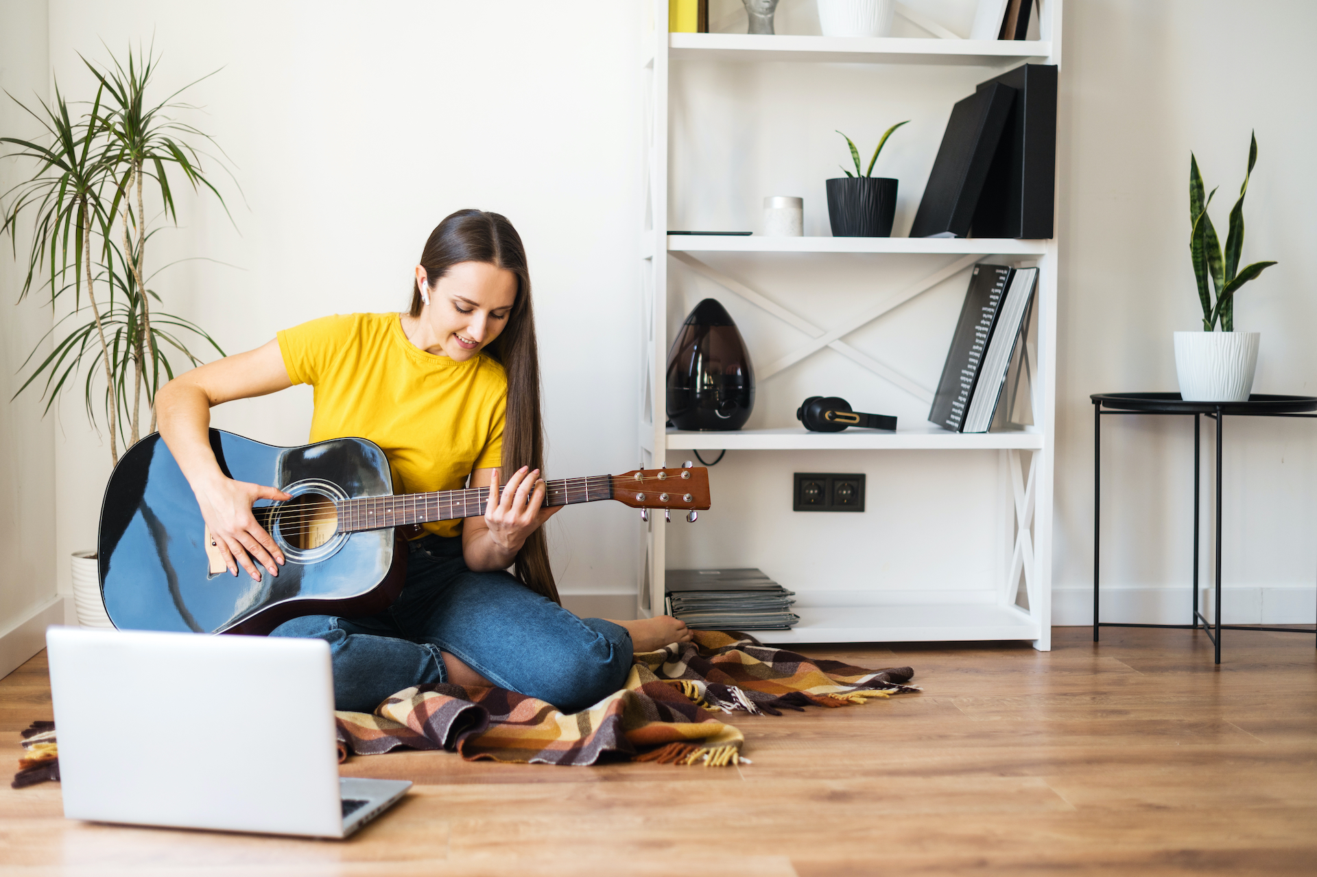 Adult practicing guitar at home