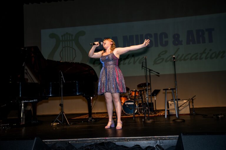 DEA students performing together on stage