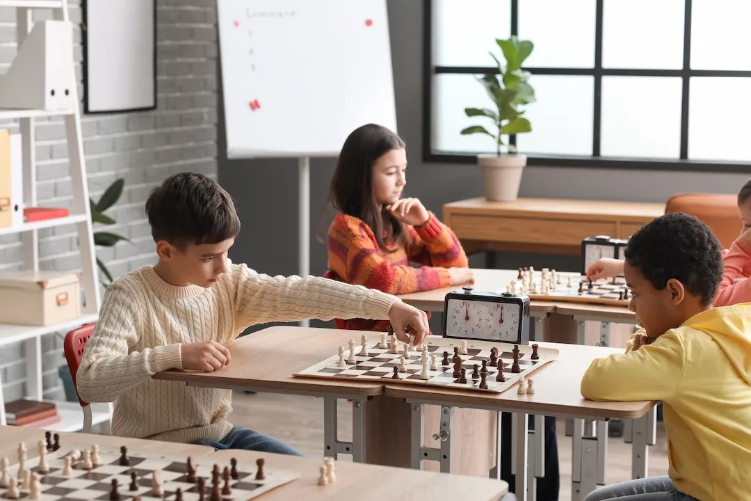 Children learning together at classroom tables