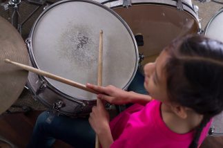 Young Girl Learning Drums